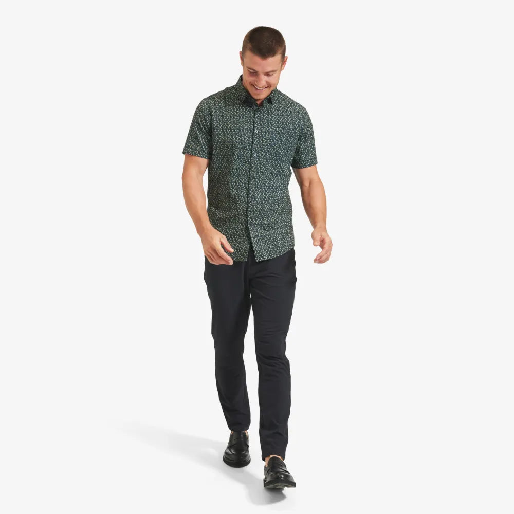man wearing navy green leaf print shirt